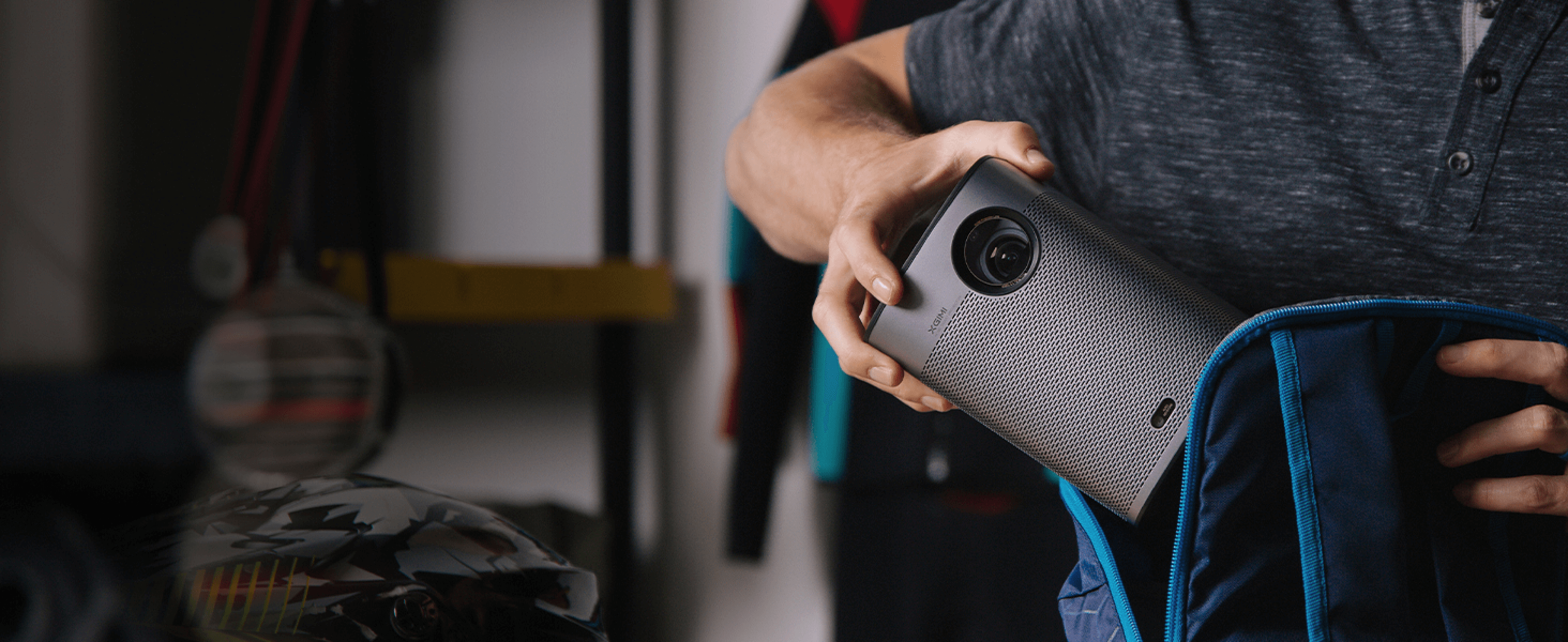 User packing the ultra-portable Halo+ (New) projector with 59Wh battery for outdoor adventure