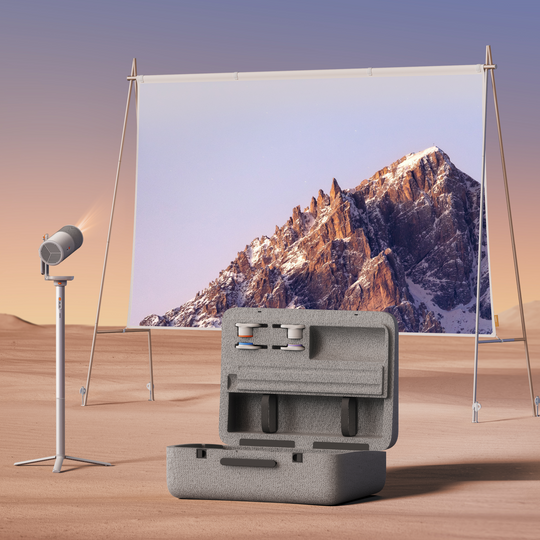 XGIMI MoGo 4 Laser portable outdoor projector in desert, projecting mountain, with open case & filters.